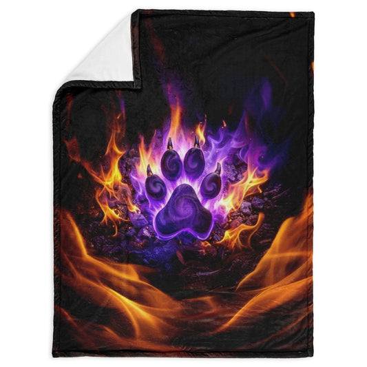 Blanket with a purple paw print design surrounded by flames on a black background